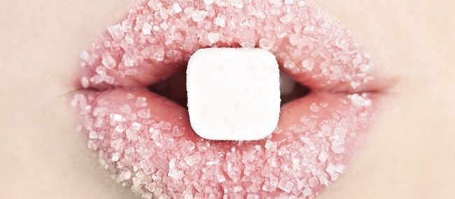 A close up of a person 's lips with pink sugar on them